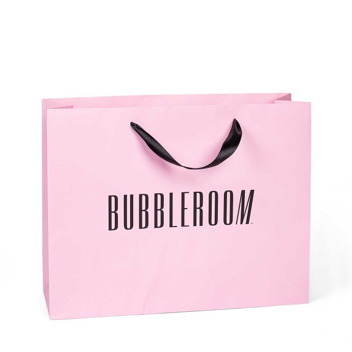 Lyxkasse med vävda handtag och tryckt logo "Bubbleroom".