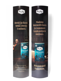 Oliksidig popup "Paulig" i fullstorlek att ställas på golvet. Den viks på 4 delar, med gummibandsmekanism och har ett blankt laminat som ger en glansig och tålig yta.