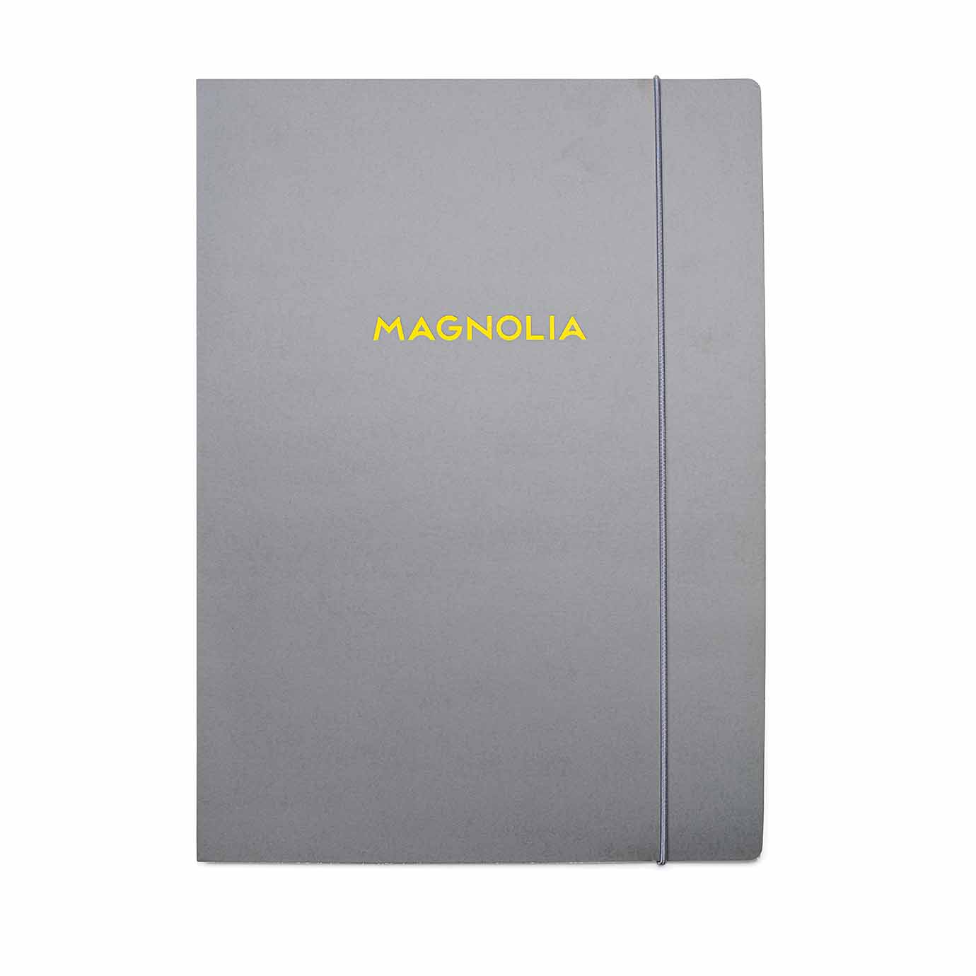 Mapp med gummisnodd och logo "Magnolia" i gul foliering.